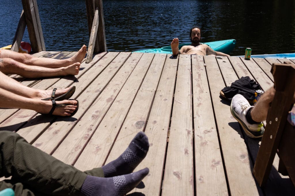 Wedding Guests sit on the dock at Leonard Lake Reserve, Mendocino