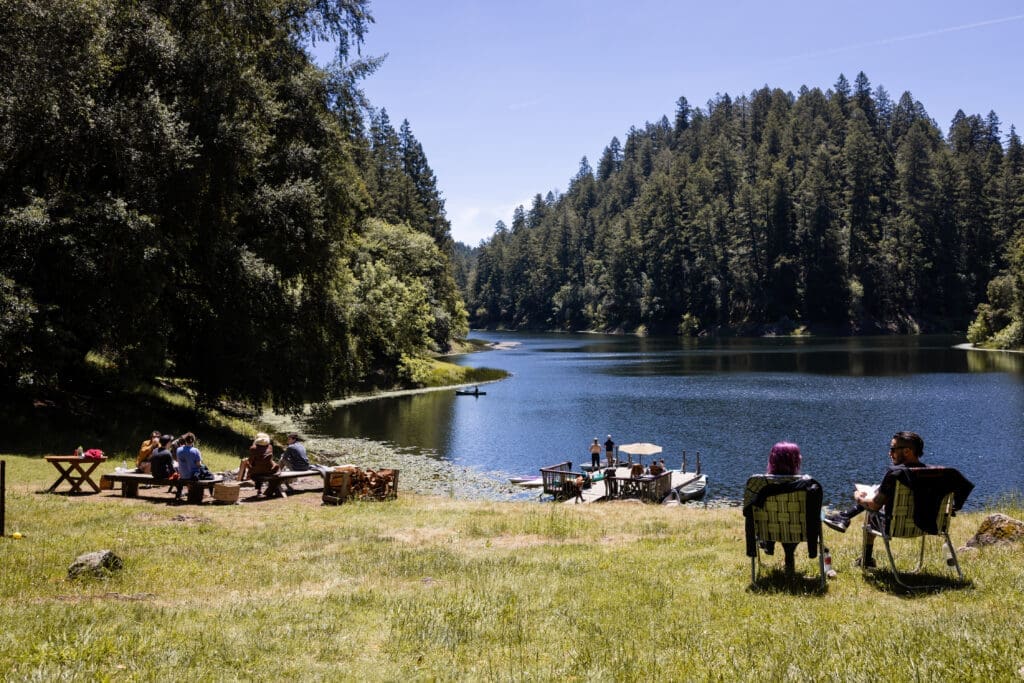 Wedding guests gathered on a lakeside at Leonard Lake Reserve in Redwood Valley California
