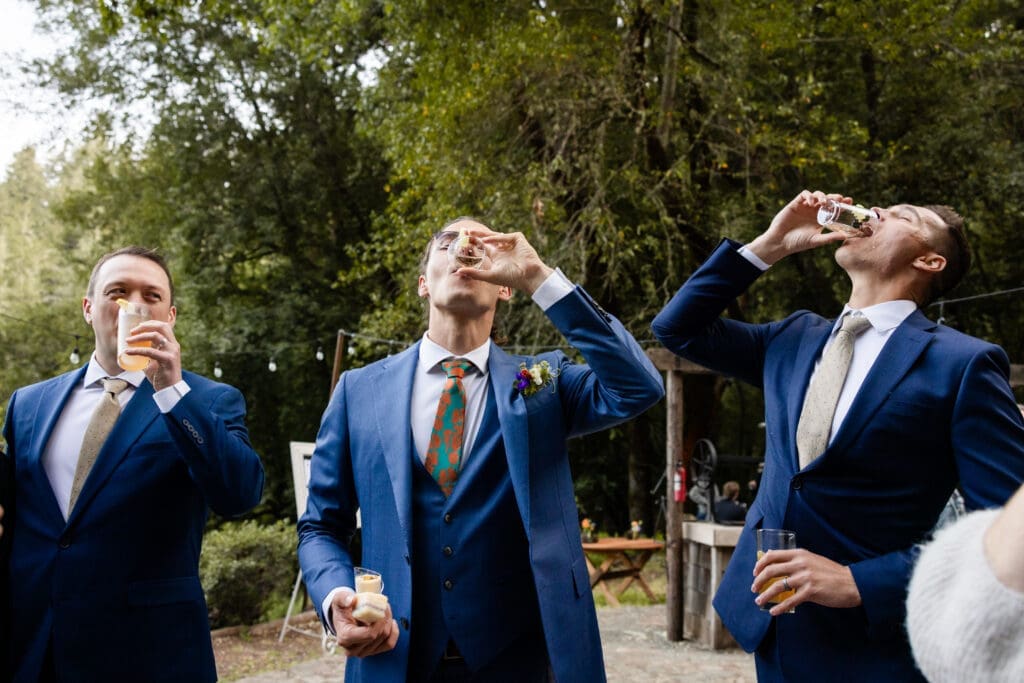 Wedding guests take shots at a Leonard Lake Reserve summer camp wedding
