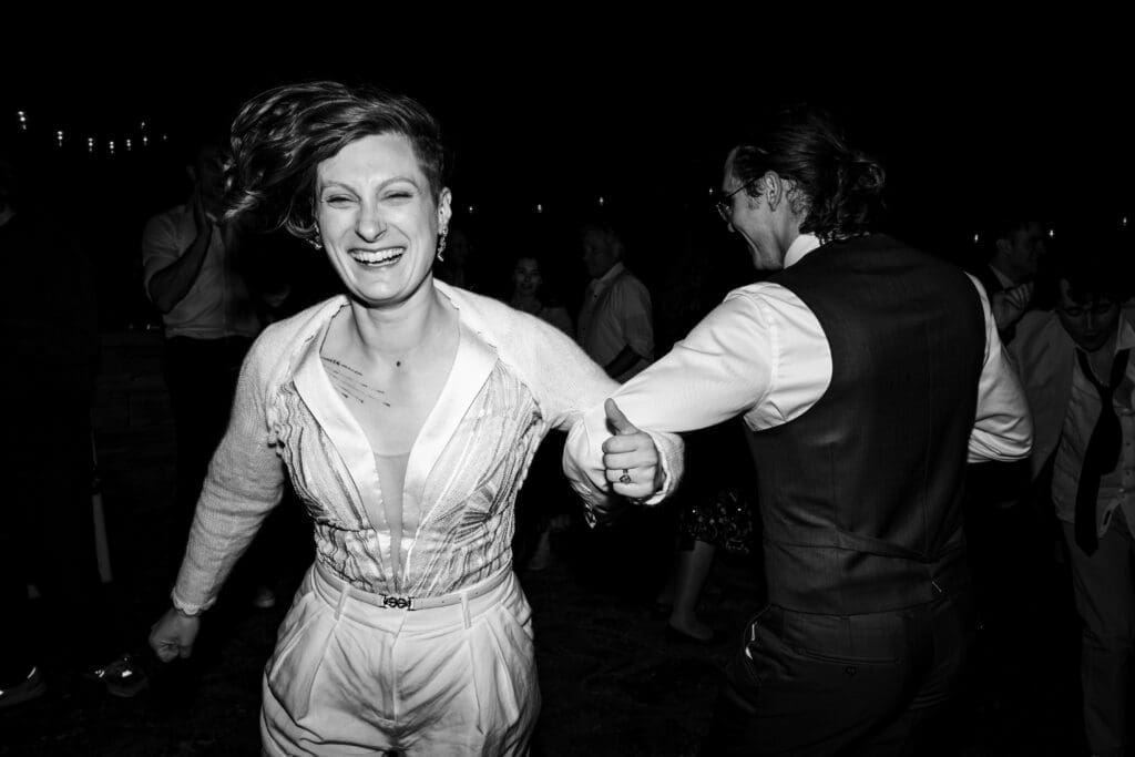 Bride and groom arm in arm singing at the end of a Mendocino retreat wedding