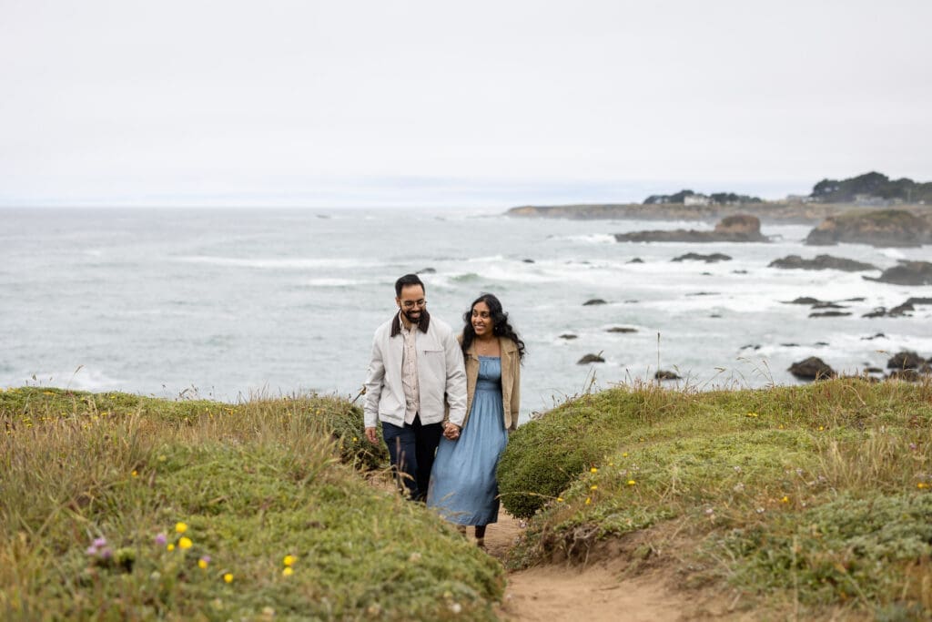 Couple walks along bluff trail at Mendocino Botanical Gardens after a surprise proposal.