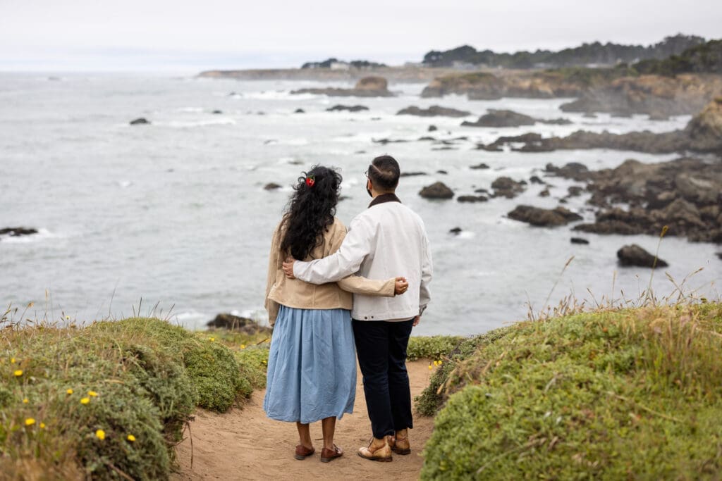 Couple admire the view of the ocean bluffs at Mendocino Botanical Gardens surprise proposal