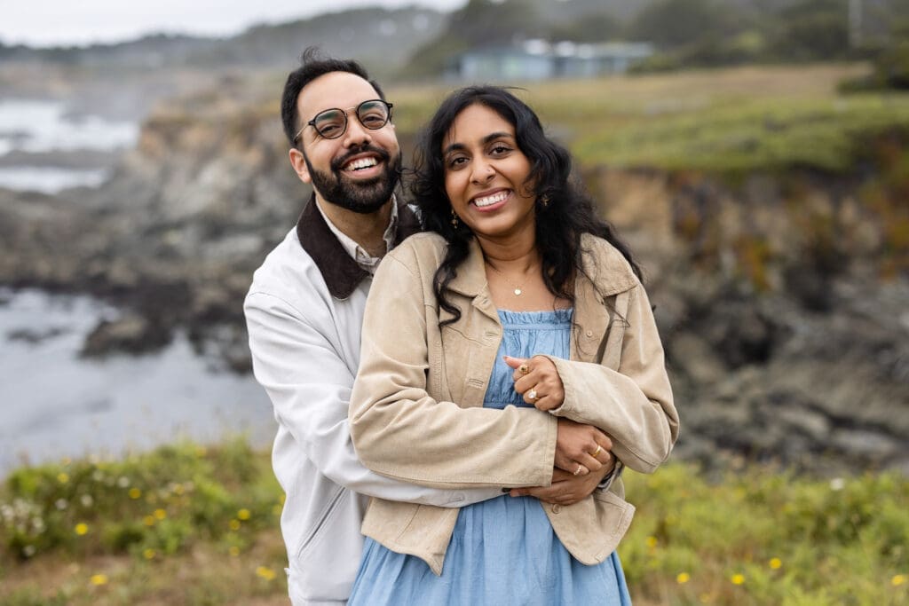 Couple embraces over bluffs at the Mendocino Botanical Gardens after surprise proposal